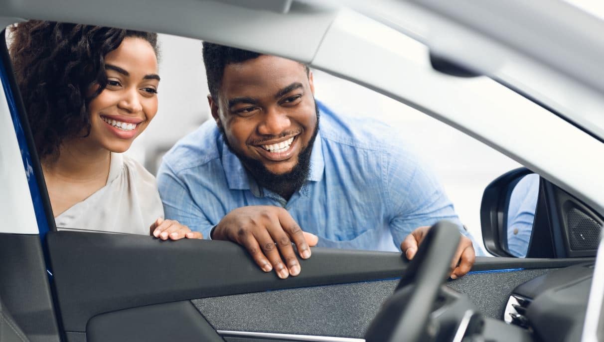 A couple checking the interior of a new car