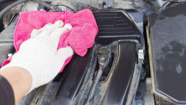 man wiping car