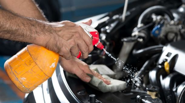 mechanic wiping down engine