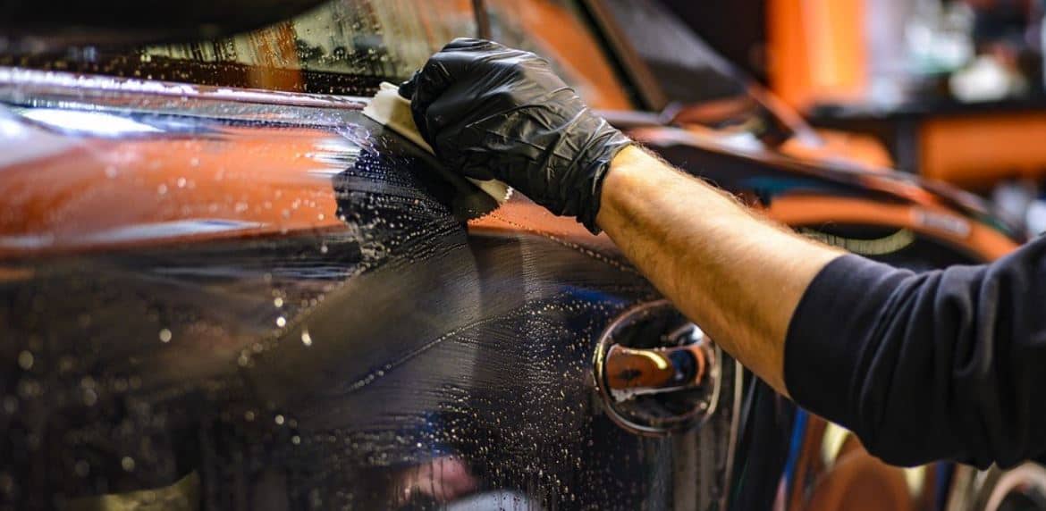 Man washing a black car